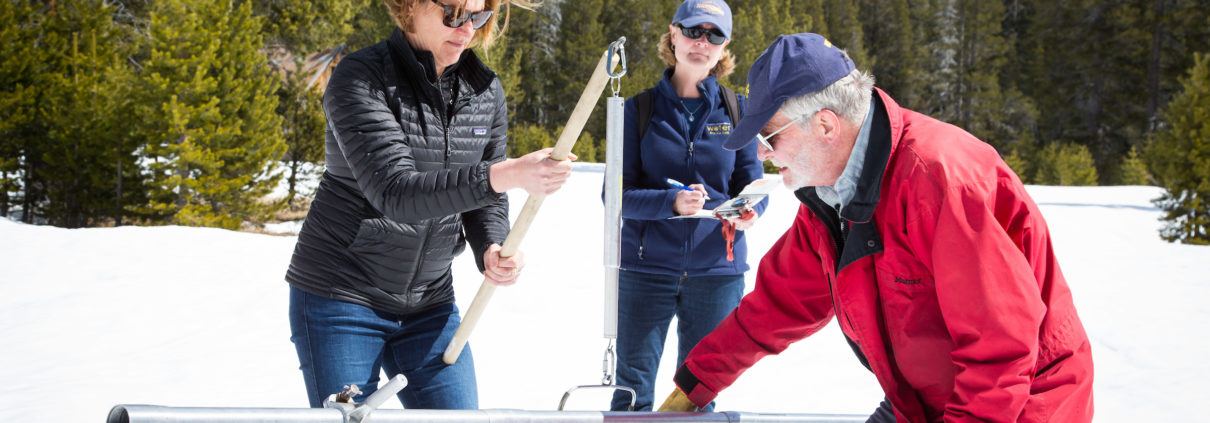 Karla Nemeth, Director of the California Department of Water Resources, left, Cindy Messer, Chief Deputy Director (DWR), center, assists Frank Gehrke, Chief of the California Cooperative Snow Surveys Program, with the fourth snow survey of 2018 at Phillips Station in the Sierra Nevada Mountains. The survey site is approximately 90 miles east of Sacramento off Highway 50 in El Dorado County. Photo: Dale Kolke / California Department of Water Resources