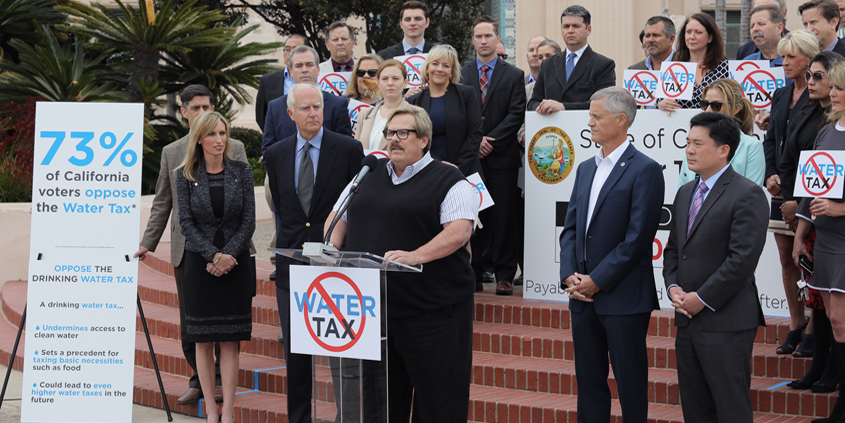Water Authority Chairman Mark Muir (center) speaks to reporters at a news conference of regional leaders announcing their opposition to a proposed state water tax. Photo: Water Authority