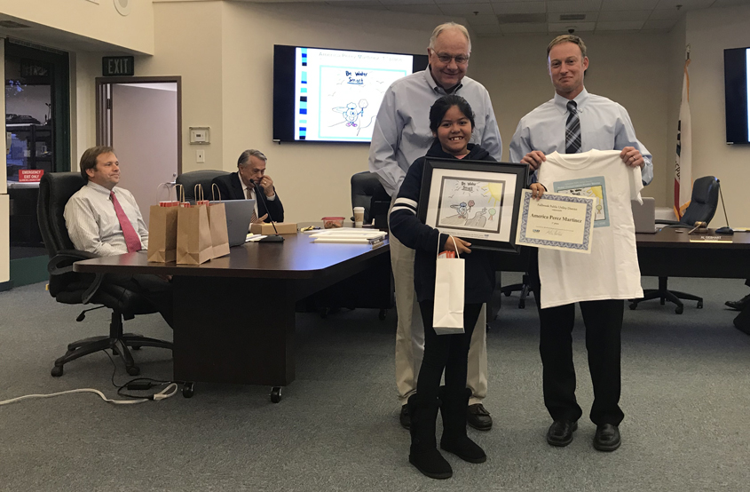 First place winner America Perez Martinez receives congratulations from Fallbrook PUD board president Al Gebhart and general manager Jack Bebee. Photo: Fallbrook PUD