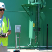 Alexander Schultz, Otay Water District geographic information systems technician, operates a drone in front of a district water storage tank. Photo: Otay Water District