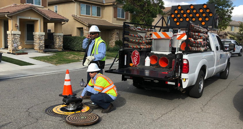 Vallecitos Water District Wastewater Collection Systems workers Dennis Richardson (standing) and David Saavedra inject smoke into the sewer system. Photo: Vallecitos Water District Smoke testing