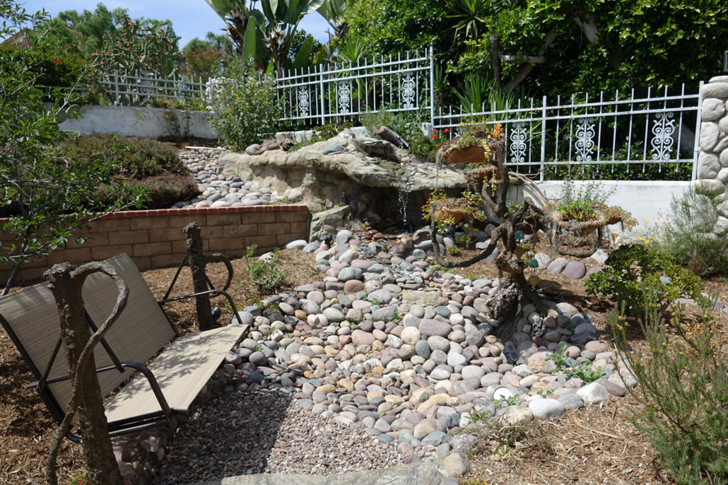 Water from the waterfall grotto travels up the faux bonsai tree in the Cissells' La Mesa Conservation Garden. Photo: Otay Water District