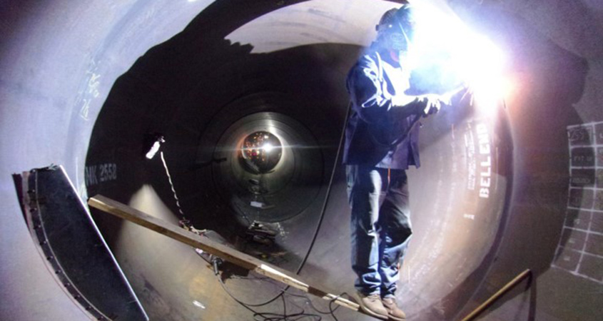 A welder works inside the pipe to connect the new joints. Photo: Water Authority