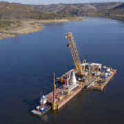 Crews loaded the 130,000 pound stainless steel cone onto a barge and finished assembling it above water before lowering it into the reservoir. Image: Water Authority