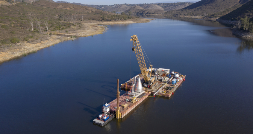 Crews loaded the 130,000 pound stainless steel cone onto a barge and finished assembling it above water before lowering it into the reservoir. Image: Water Authority