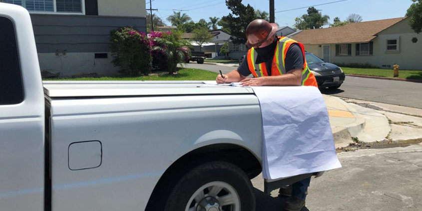 Chris Walter, Helix Water District Inspector II, works while wearing a mask as an essential employee. Photo: Helix Water District