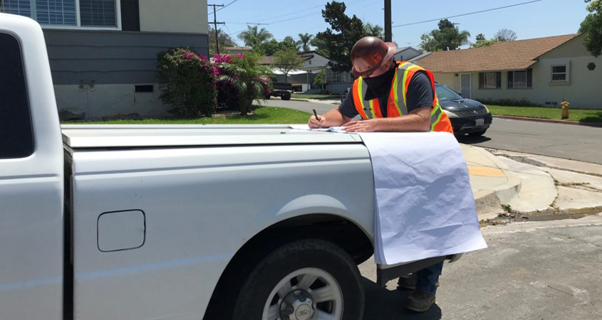 Chris Walter, Helix Water District Inspector II, works while wearing a mask as an essential employee. Photo: Helix Water District