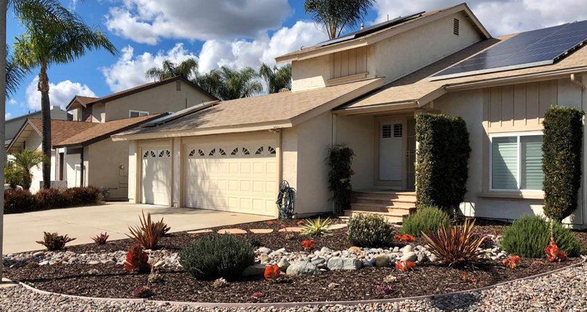 Vibrant pink, orange, purple and red succulents are interspersed among lush rosemary and lavender bushes in this award-winning landscape makeover in Santee. Photo: Padre Dam MWD