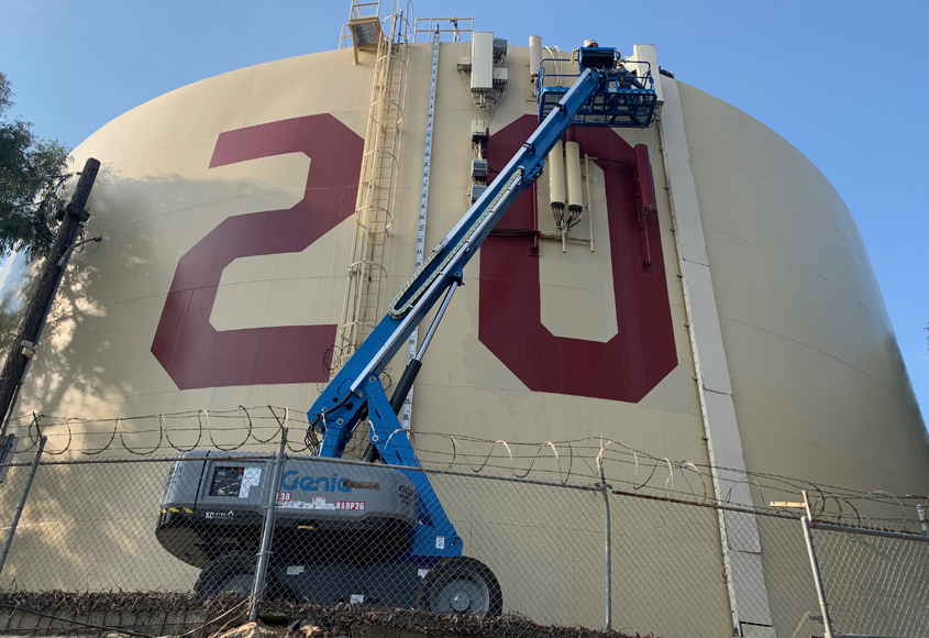 Fallbrook Public Utility District utility workers Colter Shannon and Bryan Wagner do the honors changing the painted numbers on Rattlesnake Tank for the Class of 2021. Photo: Fallbrook Public Utility District