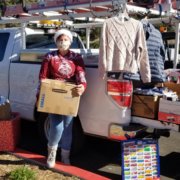 Teresa Chase helps load up donations from Olivenhain Municipal Water District employees. They are playing Santa Claus to a family of seven, a local senior, and a veteran in its annual adopt-a-family effort, and filled a truck bed with donations for the San Diego Humane Society. Photo: Olivenhain Municipal Water District