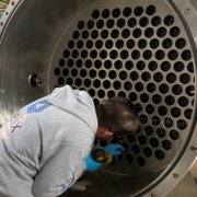 A Helix staff member installs parts in the ozone generator. Photo: Helix Water District