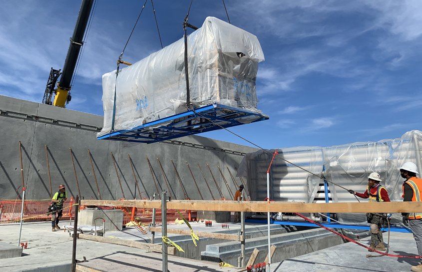 Construction personnel guide reverse osmosis skids into place. Photo: Jeremy Kemp, City of Oceanside