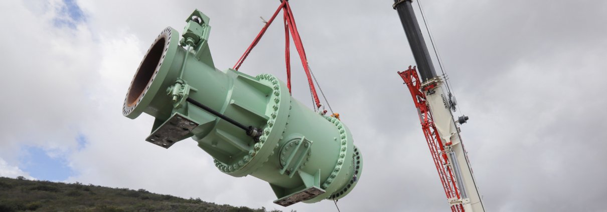 Crane lifts valve from roof