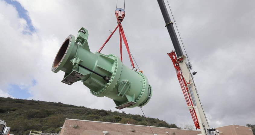 Crane lifts valve from roof