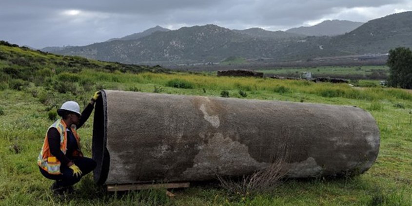 An employee looks into a section of pipeline. One of the projects receiving an award.