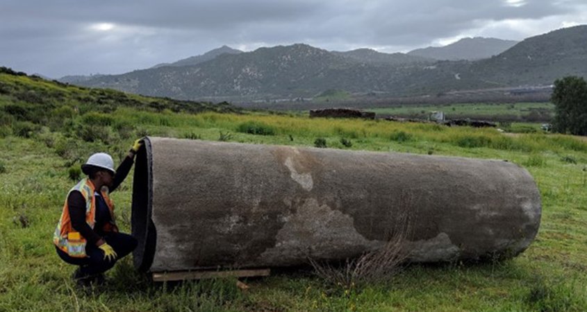 An employee looks into a section of pipeline. One of the projects receiving an award.