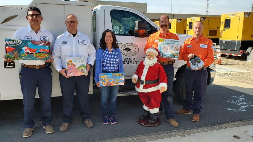 (Left to right): Poway employees Alex Limas, Fernando Ramirez, Kathy Clancy, Santa Claus (a seasonal employee), Randy Slusher and Chad Weigel with holiday donations. Photo: City of Poway 