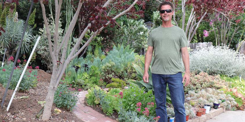 La Mesa resident Nick Voinov stands in front of his 2022 Helix Water District Landscape Contest winning yard. Photo: Helix Water District water efficient yard