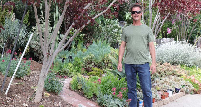 La Mesa resident Nick Voinov stands in front of his 2022 Helix Water District Landscape Contest winning yard. Photo: Helix Water District water efficient yard