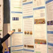 A student at the science fair showcases her project board. Innovation-technology