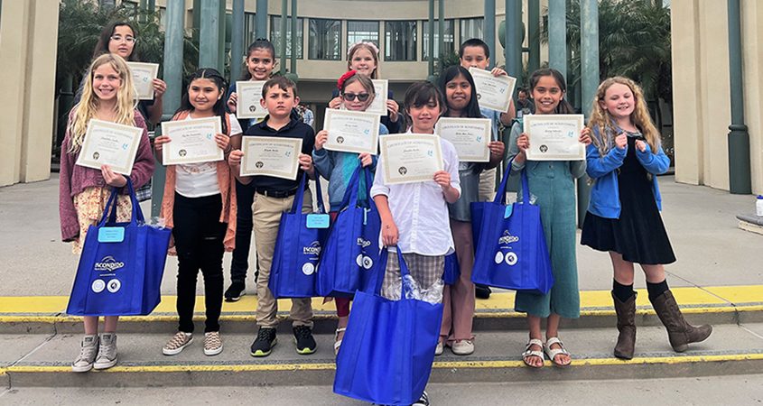 Winning artists in the 2023 Escondido Student Poster Art Contest. Front Row L-R: Annabella Trecha, Aysha Navarrete, Wyatt Hada, Avery Smith, Lincoln Steele, Belen Rios Perez, Avery Salazar, Amelia Scroggy. Back Row L-R: Aria Manoocheri, Andrea Garcia, Cassie Goodwin, Isaac Holsclaw. Photo: City of Escondido