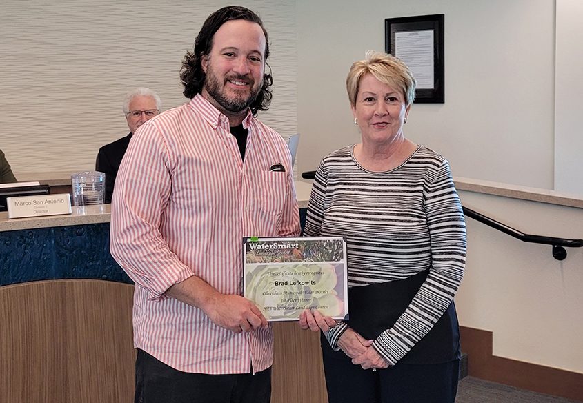 Landscape Contest Winner Brad Lefkowits receives his award from Olivenhain Municipal Water District Board Chairperson Christy Guerin at the June board meeting. Photo: Olivenhain Municipal Water District