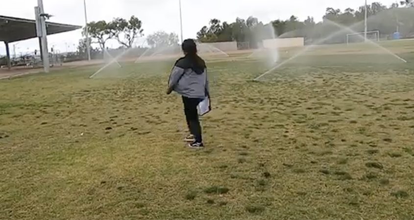 Water Conservation Specialist Arlene Acosta of WaterWise Consulting assesses irrigation coverage at San Marcos Elementary School. Photo: Vallecitos Water District San Marcos Unified