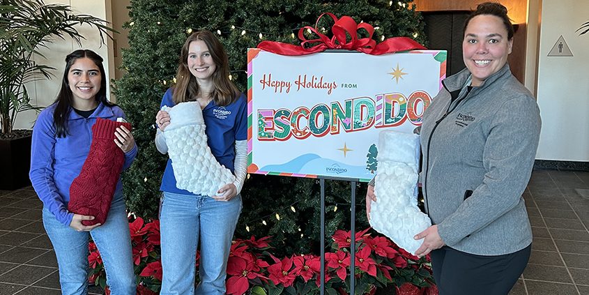 (L to R) City of Escondido Environmental Programs team members Janin Rodarte, Emily Mixer, and Marielle Decker share the holiday spirit. Photo: City of Escondido holiday giving