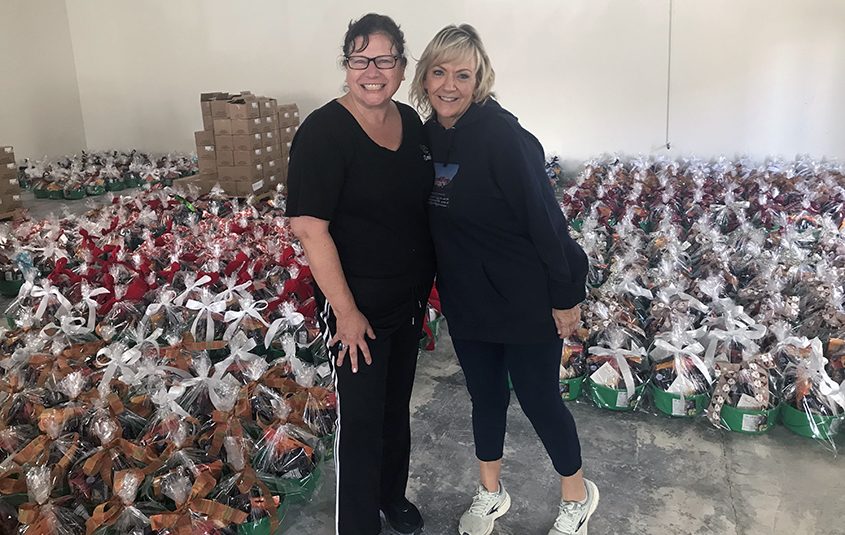 Olivenhain Municipal Water District General Manager Kim Thorner and Education and Conservation Coordinator Teresa Chase with some of the 255 nut baskets sold, with $5,610 going to Water for People. Photo: Olivenhain Municipal Water District. 