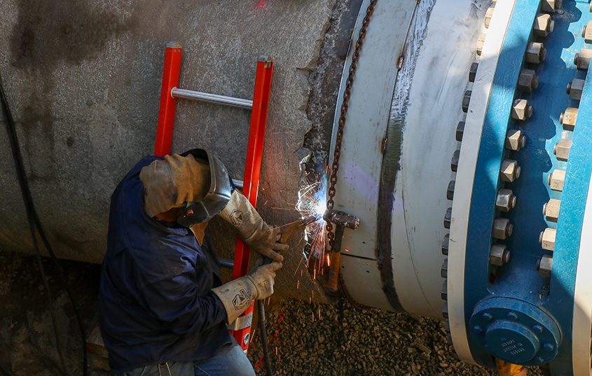 Maintenance professionals secure the new valve into place. Photo: Helix Water District