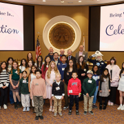 L to R (back row): Burbank Conservation Program Specialist Amy Tremmel, Metropolitan board Vice Chair Michael Camacho, Chair Ortega, Director Stephen Faessel, Director Desi Alvarez, Cucamonga Valley Water District President Randall James Reed and Metropolitan mascot Admiral Splash, with attending student artists. Photo: Metropolitan Water District of Southern California Student poster winners