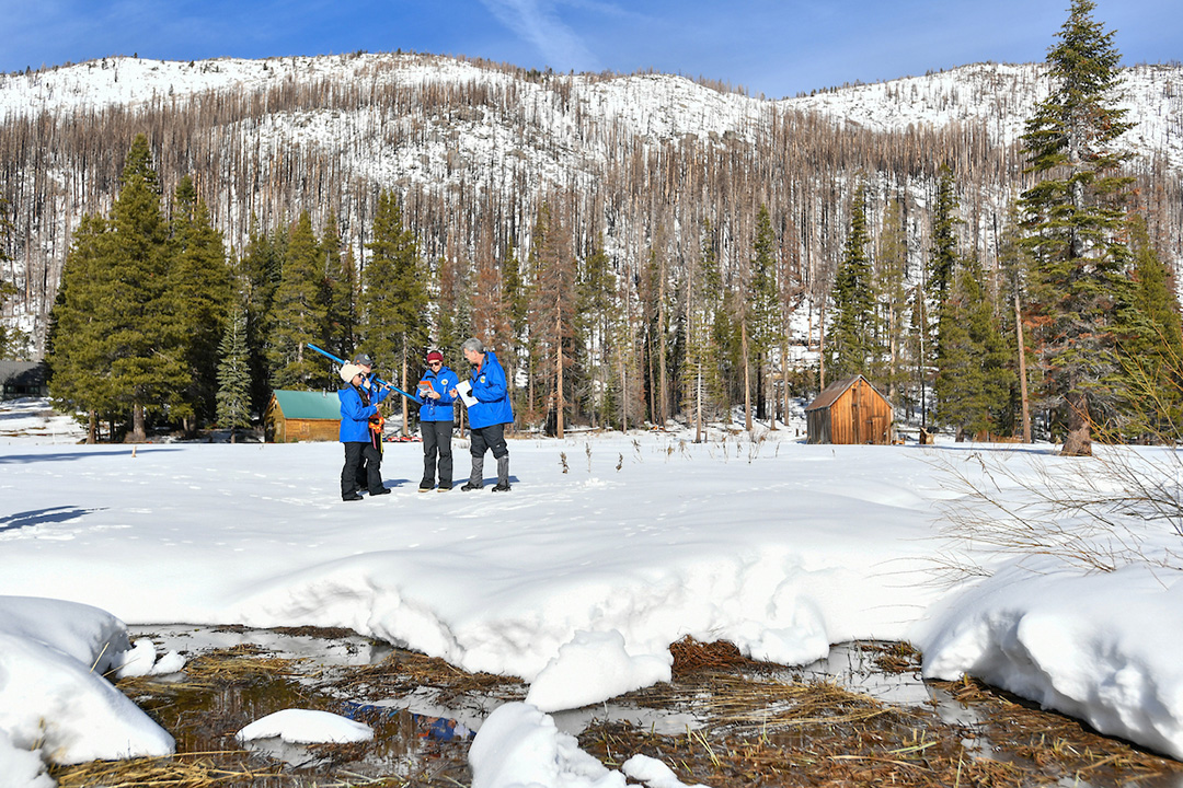 California Department of Water Resources staff members (from right) Andy Reising, Snow Surveys and Water Supply Forecasting Unit Manager, Manon von Kaenel, Water Resources Engineer, Jordan Thoennes, Water Resources Engineer, and Angelique Fabbiani-Leon, State Hydrometeorologist, conduct the first media snow survey of the 2025 season at Phillips Station in the Sierra Nevada. Photo: Nick Shockey, California Department of Water Resources