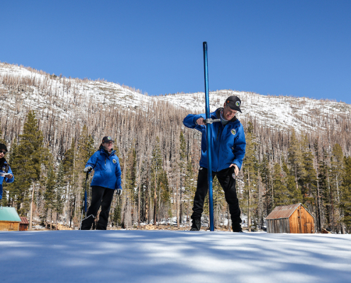 (L to R): California Department of Water Resources staff Angelique Fabbiani-Leon, State Hydrometeorologist; Jordan Thoennes, Water Resources Engineer; and Andy Reising, Snow Surveys and Water Supply Forecasting Unit Manager, conduct the third California snowpack survey of the 2025 season at Phillips Station in the Sierra Nevada. Photo: Xavier Mascareñas, California Department of Water Resources