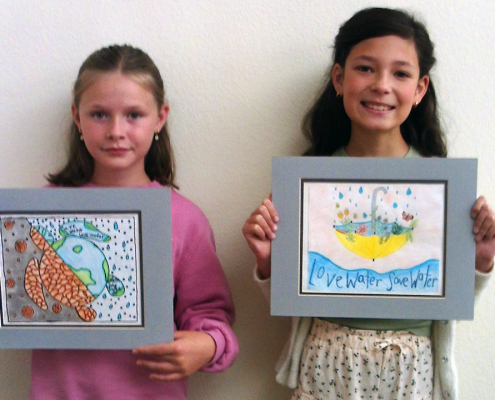 Vista fourth grade students Presley Regan and Cosette Kennedy display their award winning poster contest entries. Photo: Vista Irrigation District
