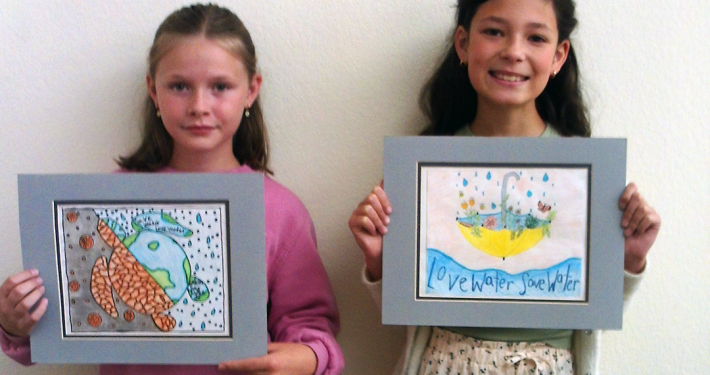 Vista fourth grade students Presley Regan and Cosette Kennedy display their award winning poster contest entries. Photo: Vista Irrigation District