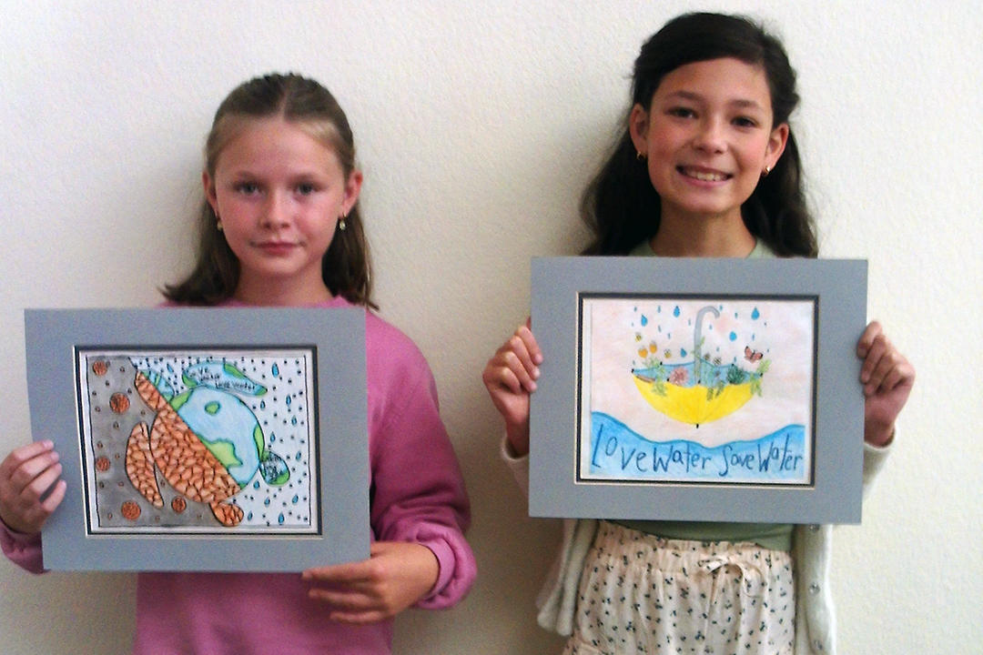 Vista fourth grade students Presley Regan and Cosette Kennedy display their award winning poster contest entries. Photo: Vista Irrigation District