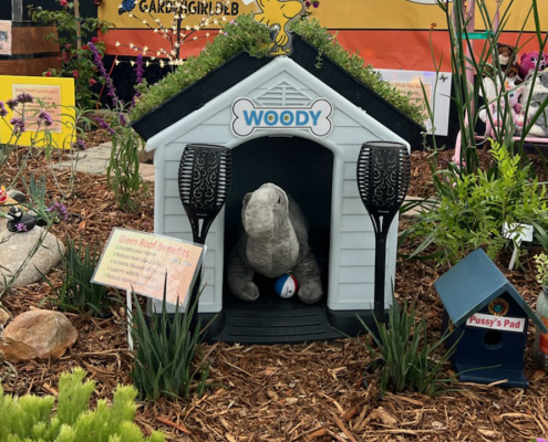 A doghouse with a green roof is one of the whimsical design elements in the award-winning "Groovy Garden" display at the 2025 San Diego County Fair Paul Ecke Jr. Garden Show. Photo: San Diego County Water Authority