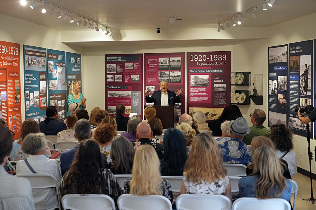 Tom Weese, son of Robert and Bessie Weese, speaks at the August 29 ribbon cutting event for the relocated Reese Oceanside History Center as historian Kristi Hawthorne looks on. Photo: Zach Cordner/The Osider.