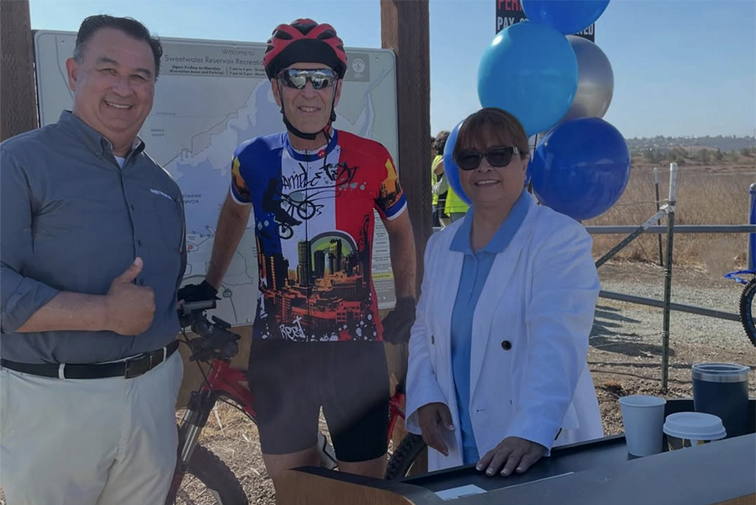 (L to R) Sweetwater Authority Assistant General Manager Roberto Yano, Otay Water District board member Mark Robak, and National City Vice Mayor, Sweetwater Authority vice chair and San Diego County Water Authority board member Ditas Yamane at the ribbon cutting for the new Sweetwater Reservoir southern trail. Photo: Susie Murphy, @CVBikeMom63/Instagram for San Diego Mountain Biking Association