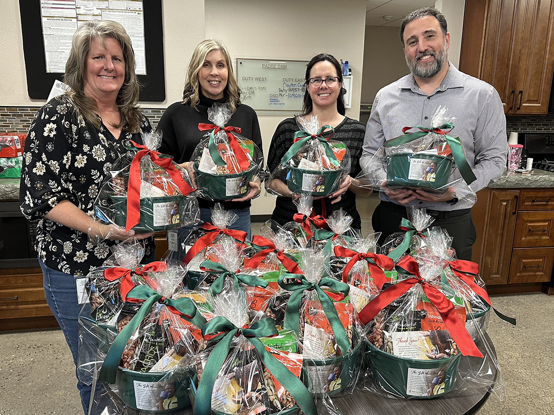 The Padre Dam MWD team enjoyed putting these baskets together. (L to R): Michelle Revilla, Accounting Specialist/Payroll Specialist-AWP, Marie Southwick, Administrative Assistant, Adrienne Borden, Financial Analyst, and Ben Brugman, Accountant. Photo: Padre Dam Municipal Water District holiday giving