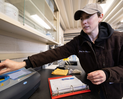 California Department of Water Resources Hydroelectric Plant Operator Apprentice Katie Swadener demonstrates how to monitor for water quality. Photo: Andrew Nixon / California Department of Water Resources