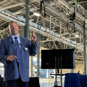 Helix Water District Kevin Miller highlights the new overhead EV charging infrastructure at the Nat L. Eggert Operations Center. Photo: San Diego County Water Authority