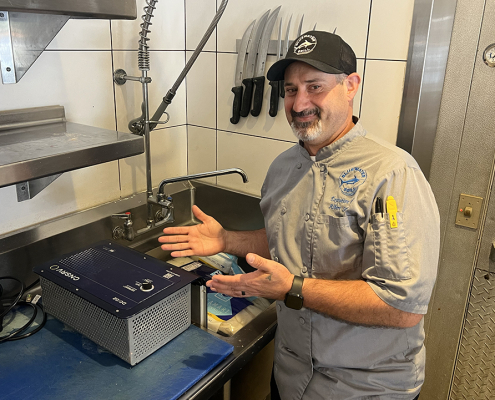 Bluewater Grill Executive Chief Albert Serrano with the CNSRV defrosting unit at his Carlsbad restaurant. Photo: San Diego County Water Authority