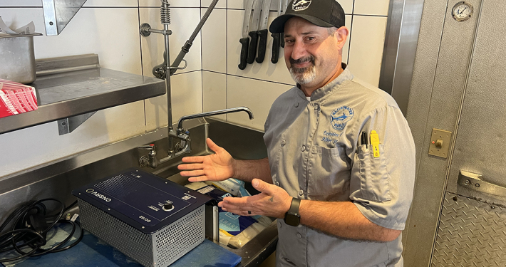 Bluewater Grill Executive Chief Albert Serrano with the CNSRV defrosting unit at his Carlsbad restaurant. Photo: San Diego County Water Authority